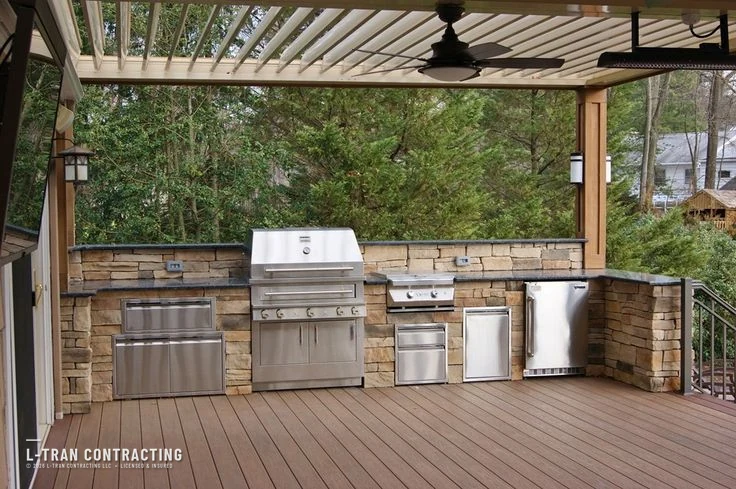 Deck with custom stone outdoor kitchen and stainless appliances