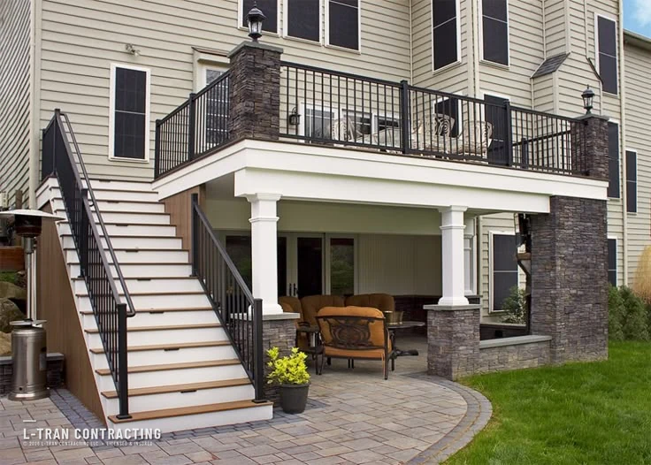 Multi-level deck with stone columns and covered patio below