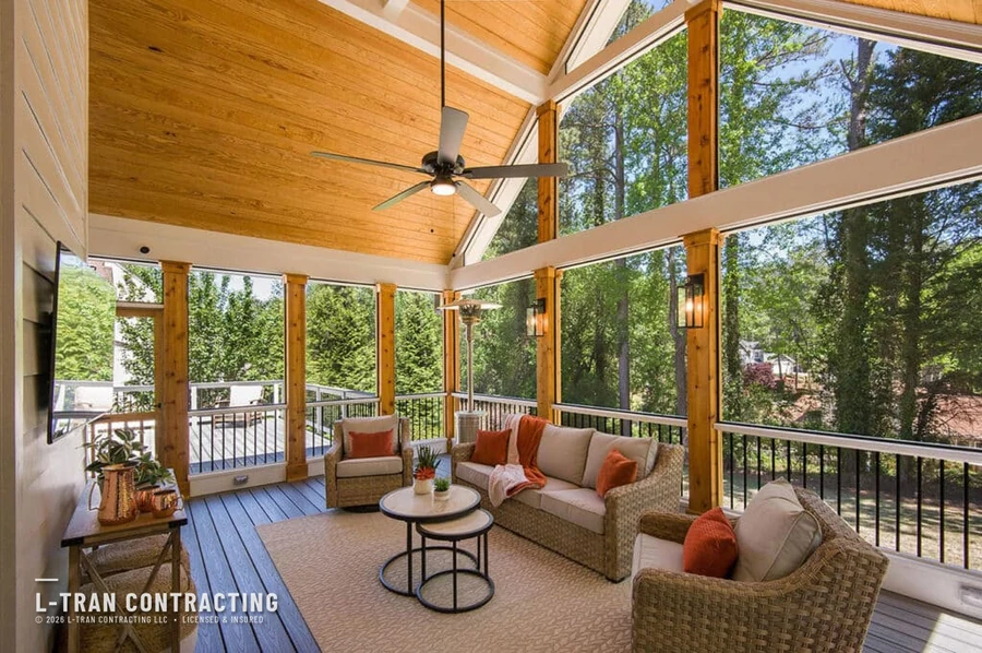 Vaulted screened-in porch with wicker furniture