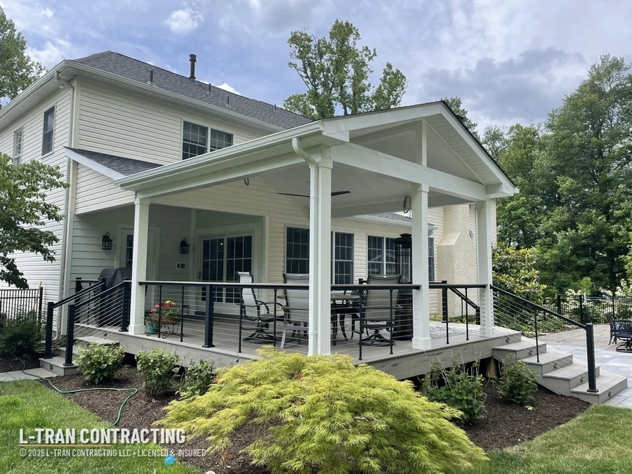 Gable-roof covered porch with cable railing