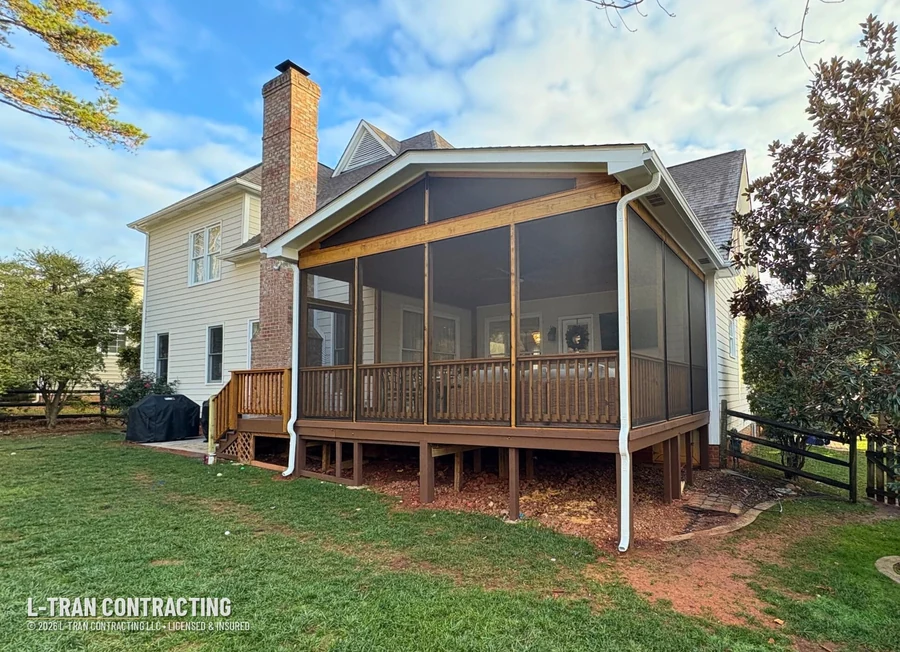 Screened porch with brick chimney and black screen panels