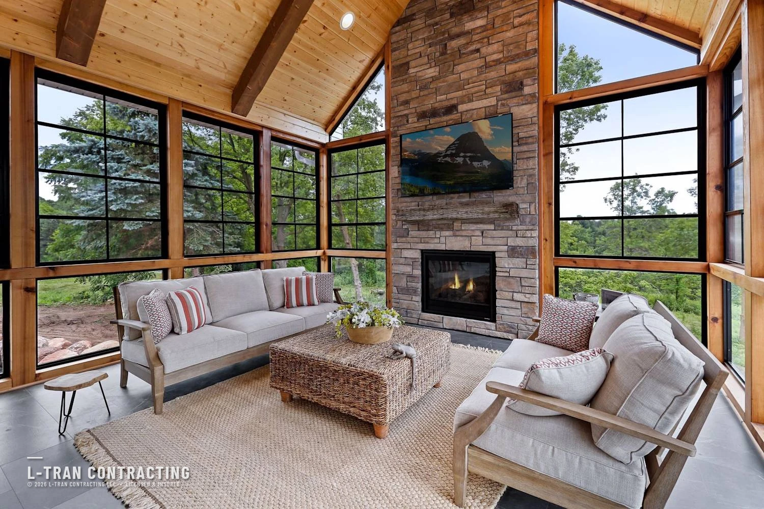 Screened porch with stone fireplace built by L-Tran Contracting