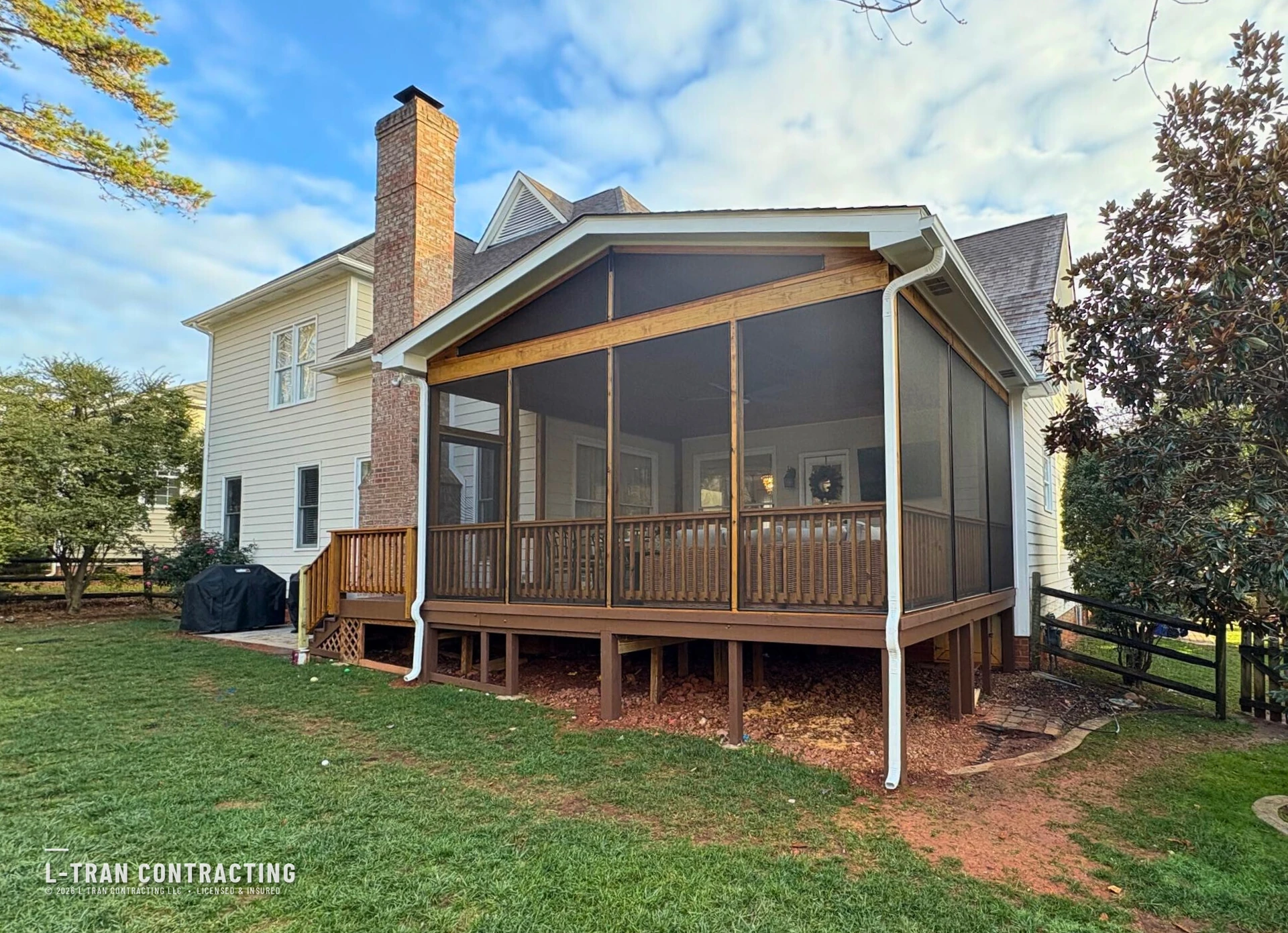 Screened-in porch with vaulted wood ceiling built by L-Tran Contracting